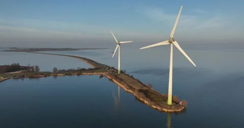 Two wind turbines at sunset, Marken, The Netherlands. Stock Footage 304498550