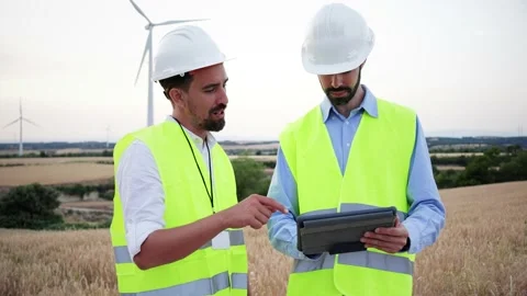 Two windmill turbine engineers working together, one technician using a tablet Stock Footage 235226631