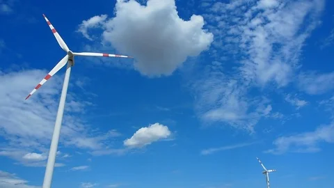 Two windmills rotating during windy summer cloudy day Stock Footage 77551171