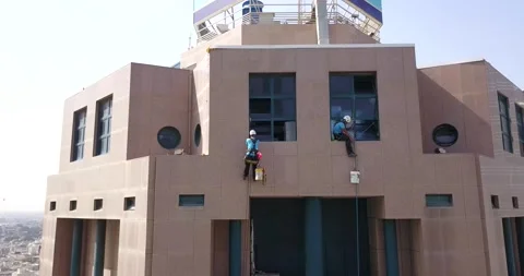 Two window cleaners starting working in a building Stock Footage 145390630