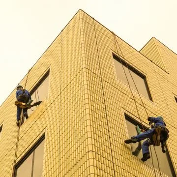Two window washers at work. Stock Photos
