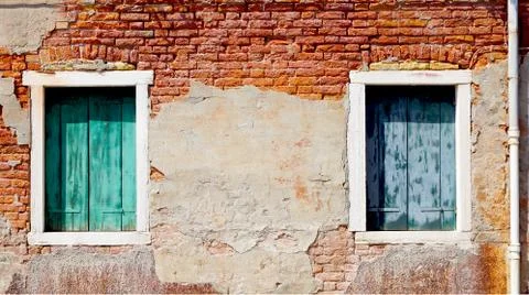 Two windows and ancient decay brick wall Stock Photos