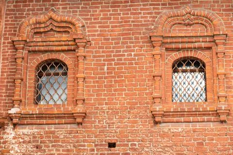 Two windows with brick trims in an old red brick wall, brick background Stock Photos