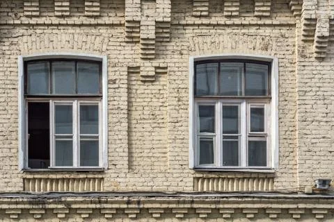 Two windows on a brick wall. Stock Photos
