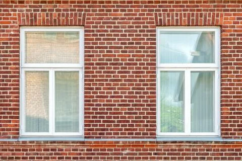 Two Windows on a brick wall. Stock Photos