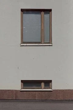 Two windows on a building facade. Stock Photos