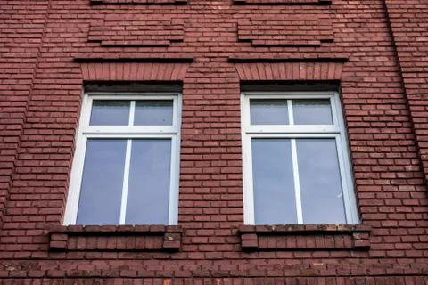 Two windows in a damaged red brick wall Fotos Stock