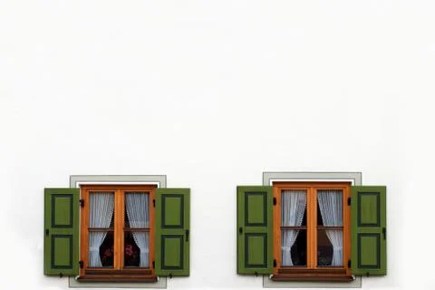 Two windows with green shutters open Stock Photos