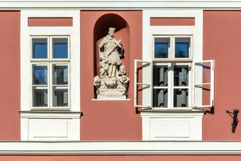 Two windows with a sculpture. Stock Photos