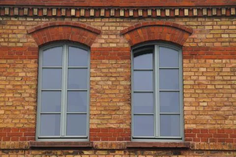 Two windows with sprouts, in a clinker wall Stock Photos