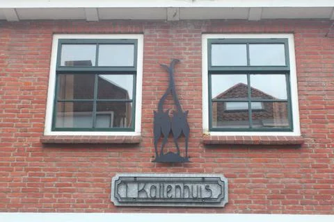Two windows with sprouts, in a red clinker wall Stock Photos