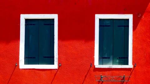Two windows with white frame on red color wall Stock Photos