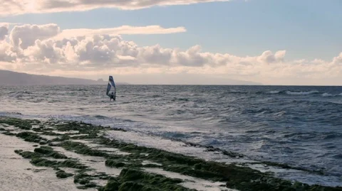 Two windsurfers making the most of the waves on a windy day. Video stock 88342906