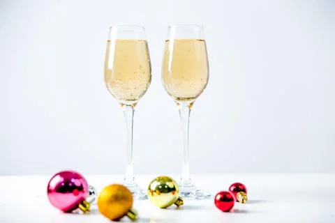 Two wine glasses with a garland on a table Stock Photos