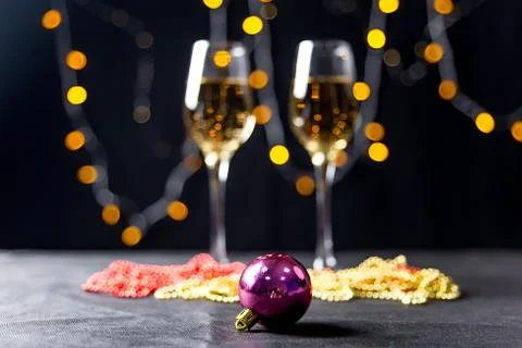 Two wine glasses with a garland on a table Stock Photos