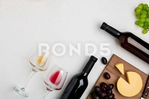 Two wine glasses with red and white wine,bottles of red wine and white wine Stock Photos