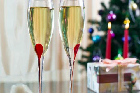 Two wineglass with champagne, Christmas spruce, gifts and candles Stock Photos