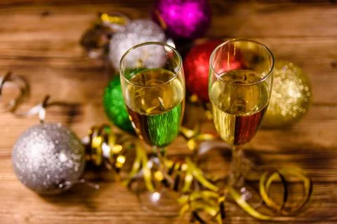 Two wineglasses with champagne and different christmas decorations on wooden  Stock Photos
