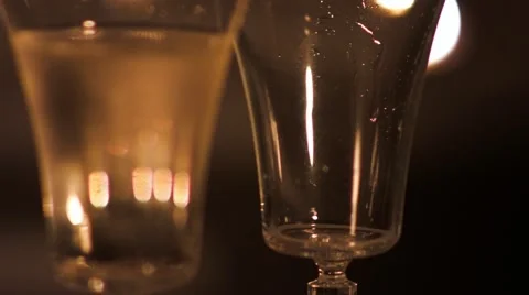 Two wineglasses. One is full and the other is being poured with champagne. Stock-Footage 42820180