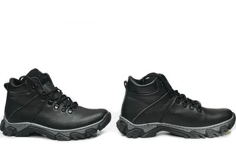 Two winter black leather boot sneaker shoes with laces on white Stock Photos