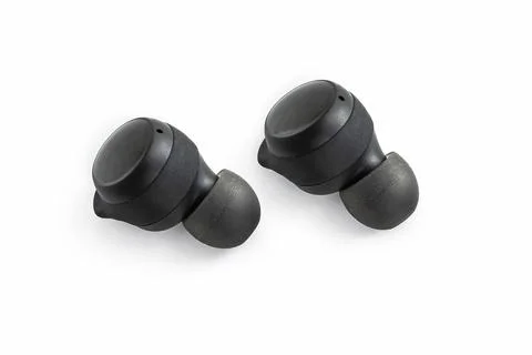Two wireless headset closeup. Wireless headphones on a white background. Stock Photos
