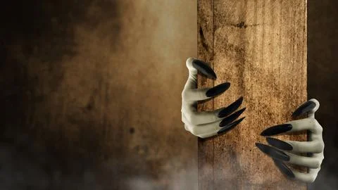 Two witch hands reaching out from a wooden post on dark background. Scene i.. Stock Photos