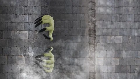 Two witch hands reaching out from behind brick wall on dark background. Sce.. Stock Photos