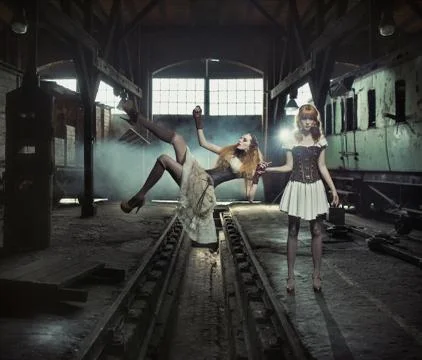 Two witches in the old and empty railway station 스톡 사진