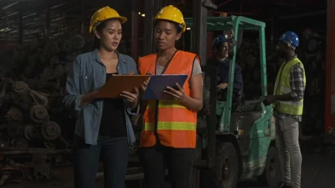 Two woman industrial engineers hold clipboard and talking at factory. Stock Footage 143956953