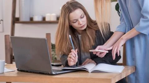 Two womans work in team. two women are discussing a new project, teamwork of Stock Photos