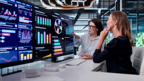 Two Women Analyzing Financial Data Together Stock Footage 340404582