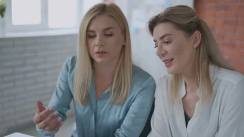 Two women are working on a project. girls work on the tablet. modern office Stock Footage 121249971