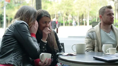 Two women backbite a man in the restaurant, outside Stock Footage 36636222