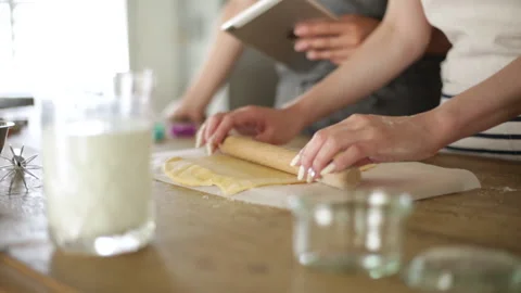 Two women  baking while checking recipe on tablet Stock Footage 159699841