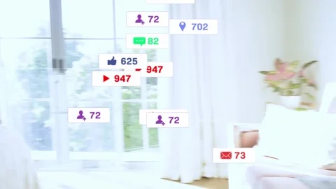 Two women on bed, tapping phone, causing animated likes, hearts, followers Stock Footage 333255994