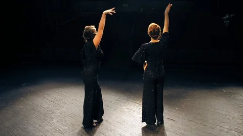 Two women in black leave theatrical scene in the dark. The end of the play Stock Footage