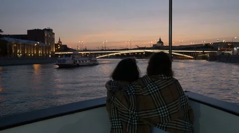 Two women on boat, sunset, river,  Stock Footage