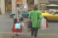 Two women carrying multiple shopping bags get into a cab in Manhattan Footage