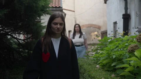 Two women chat while strolling through leafy Old Town streets. Stock Footage 308297546