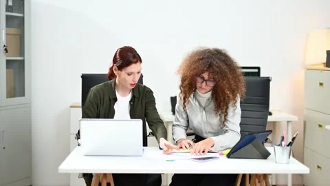 Two women coding together in a high-tech office, showcasing teamwork, softw.. Stock Footage 312387341