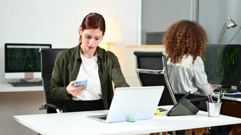 Two women coding together in a high-tech office, showcasing teamwork, softw.. Stock Footage 312387385