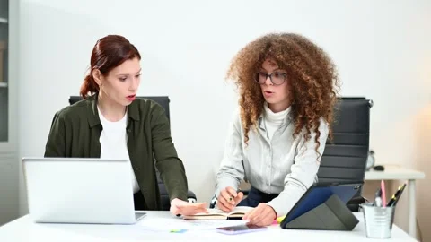 Two women coding together in a high-tech office, showcasing teamwork, softw.. Stock Footage 312603049