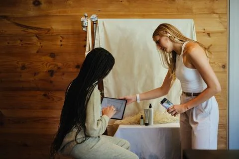 Two women collaborating on content creation in a creative workspace Stock Photos