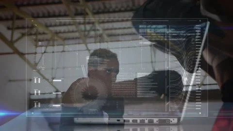 Two women collaborating with laptop in tech loft, interacting with augmented Stock Footage 307946253