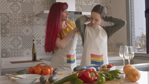 Two Women Cooking and Drinking Wine in Kitchen 库存影片 334318232