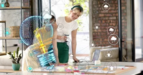 Two women creating in loft, standing woman tapping trackpad, finalizing design 動画素材 321782036