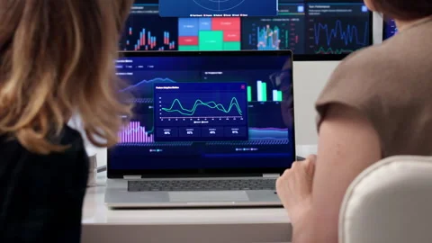 Two Women Discuss Financial Data On Laptop Stock Footage 340404816