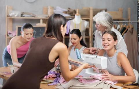 Two women discussing pattern at sewing master class Stock Photos