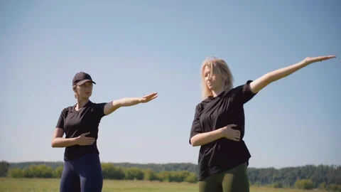 Two women doing stretching exercises outdoors Stockbeeldmateriaal 331465002