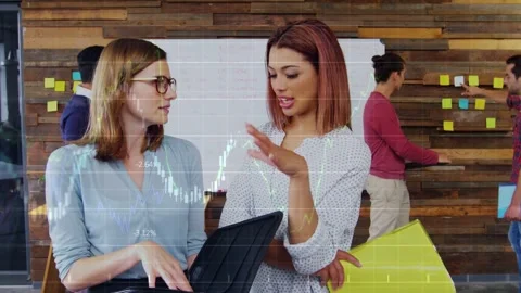 Two women examining folio and pointing, causing chart overlay rising across Stock Footage 332591995